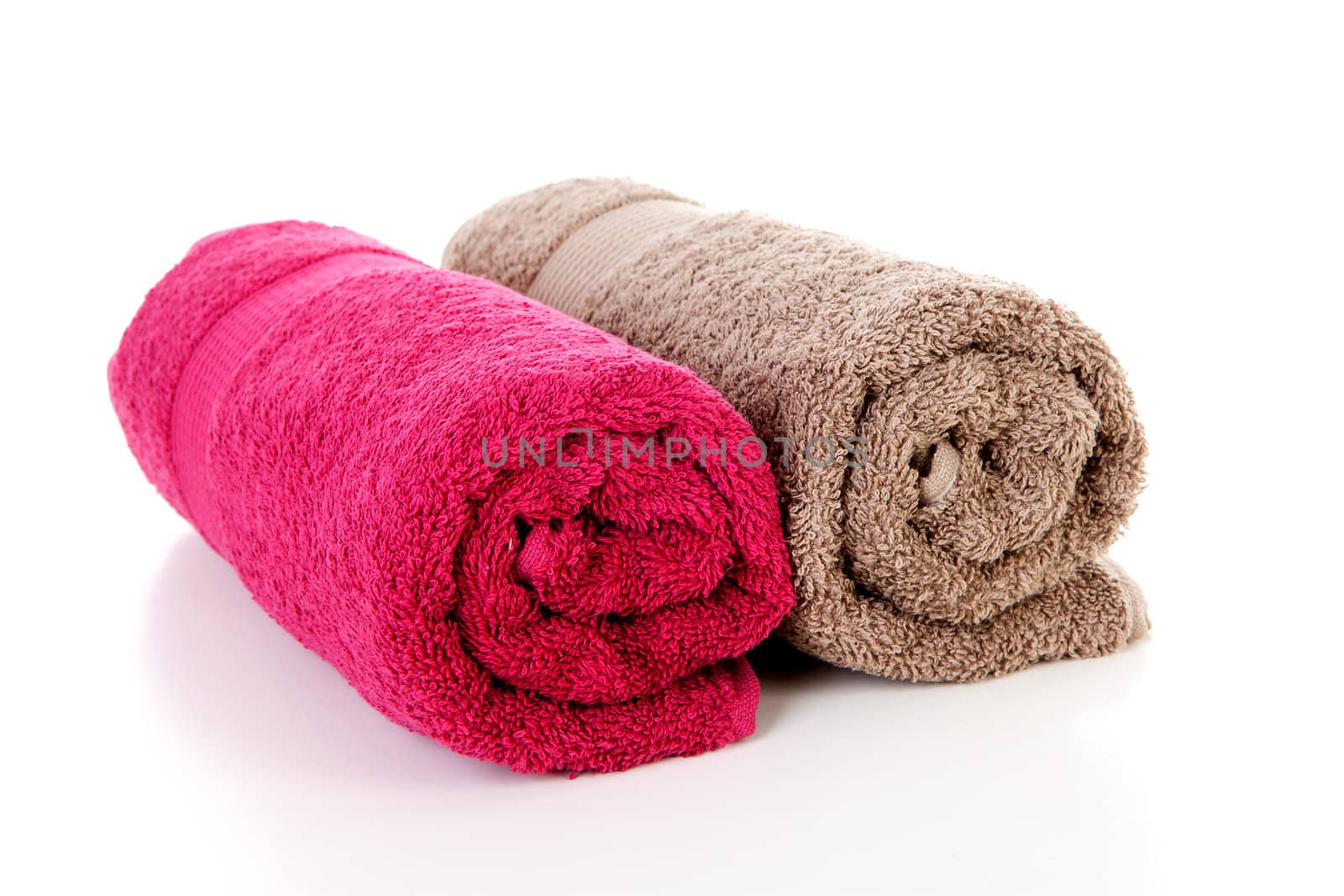 Two rolled colorful towels over white background