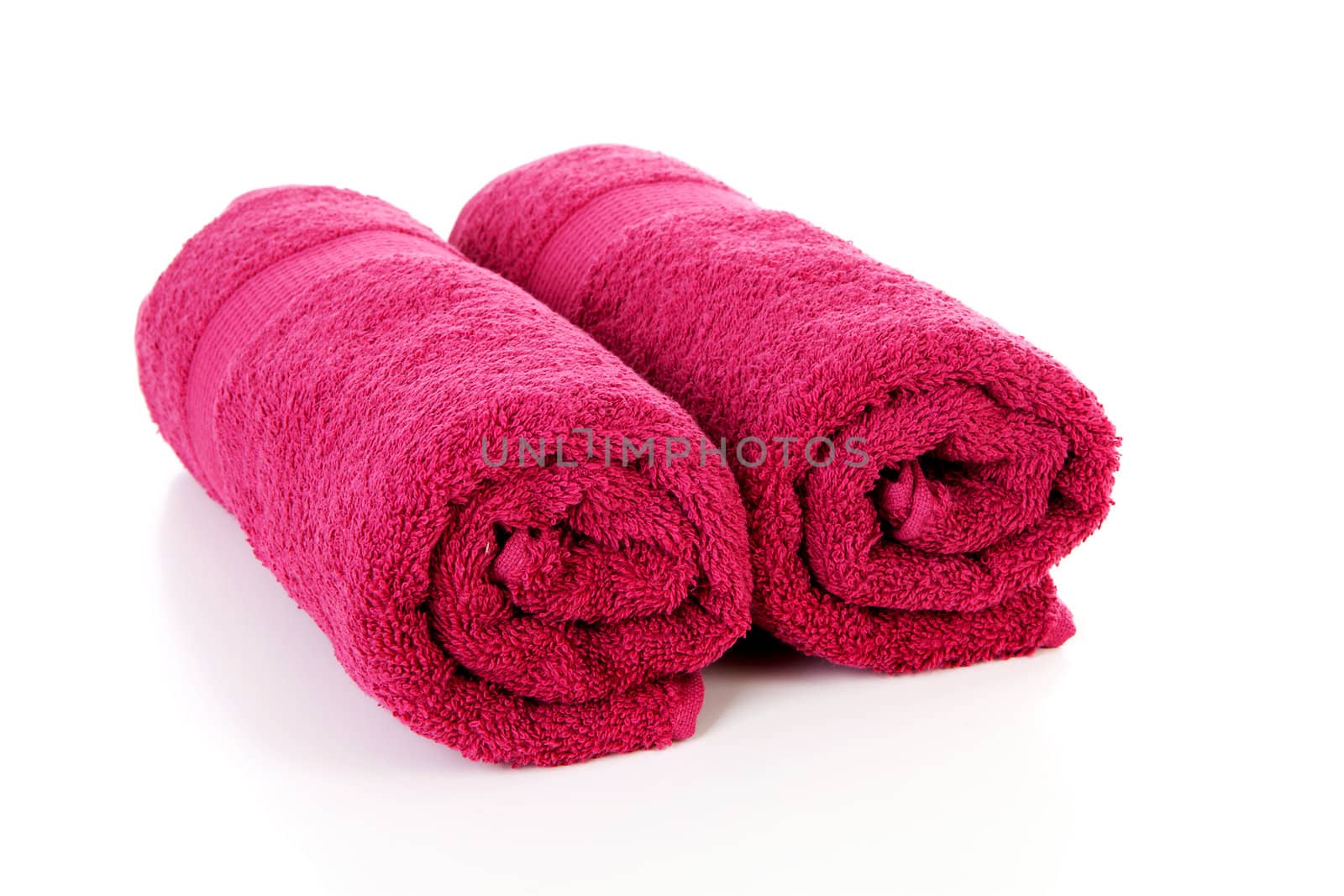 Two rolled colorful towels over white background