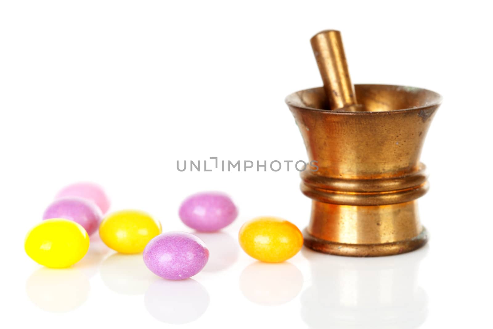 Copper mortar with colorful medicine isolated on white background
