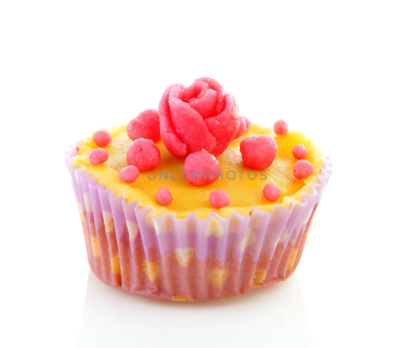 cupcake with marzipan roses decoration over white background 