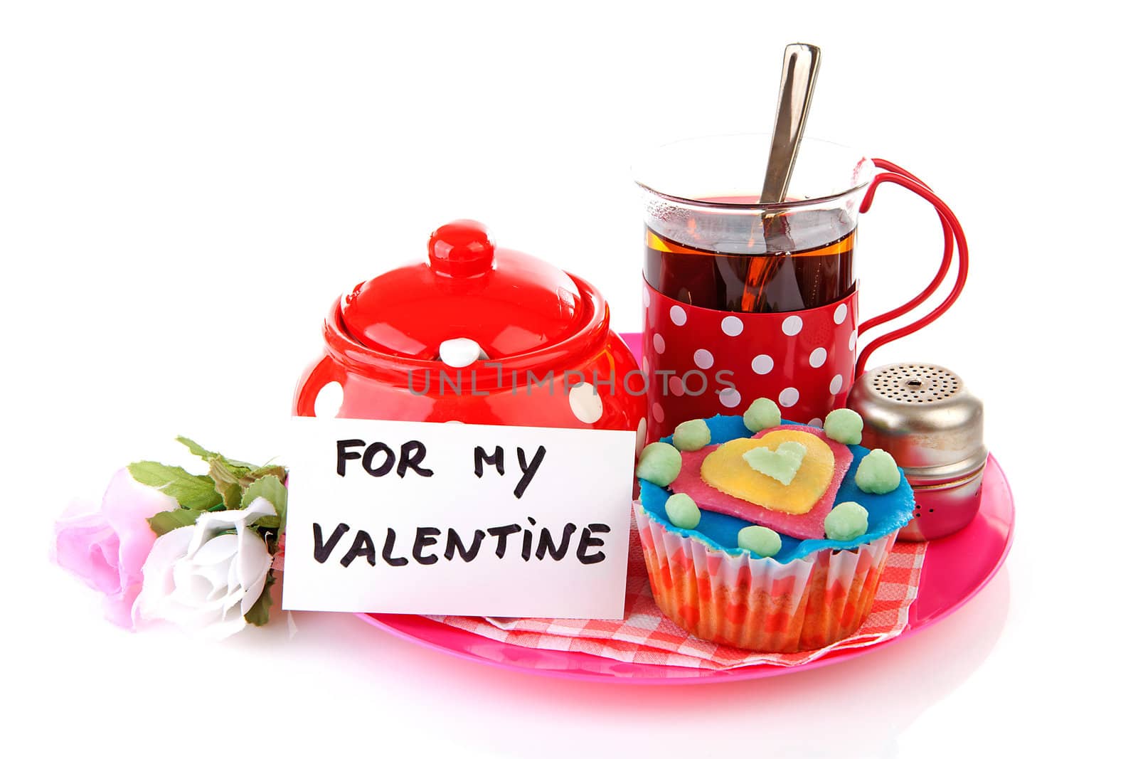 breakfast for my Valentine; cup of tea and cupcake over white background