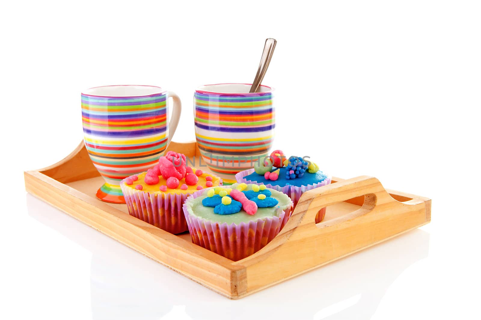 Tray with delicious decorated colorful cupcakes and cup of coffee over white background