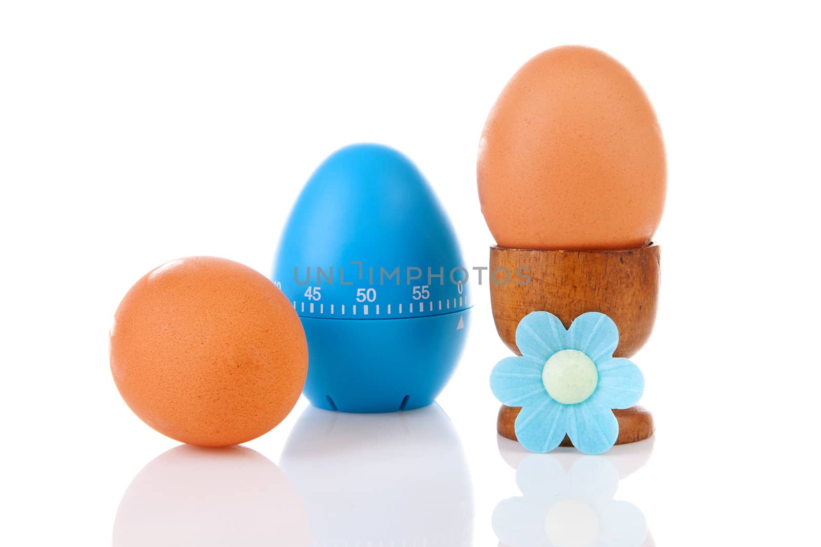 Chicken eggs with blue timer over white background