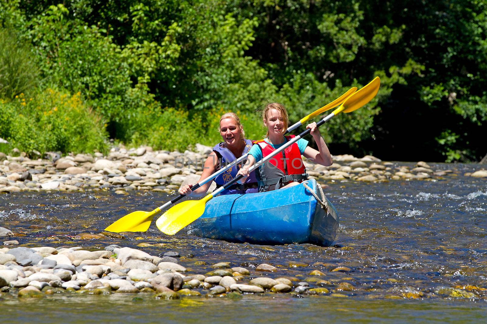 Two people in canoe enjoying holidays and nice weather in the Ardeche