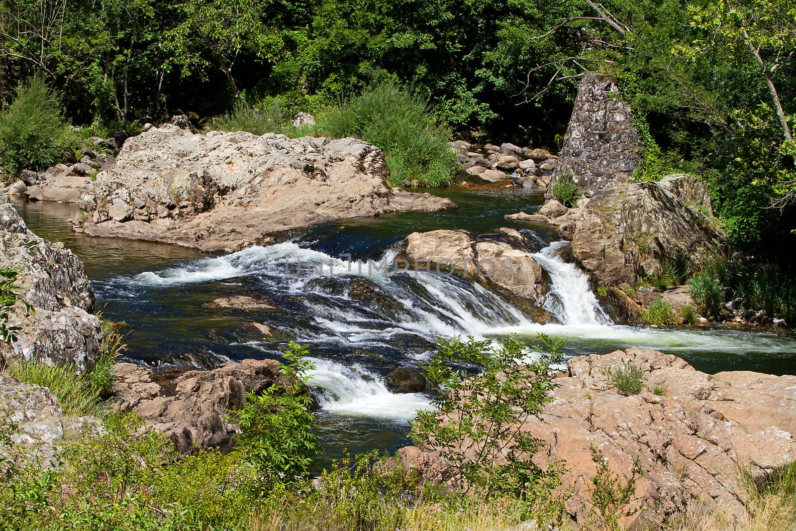 Landscape with little waterfall in the river