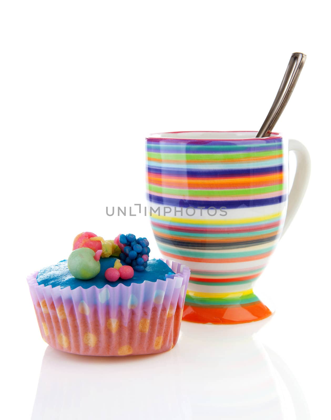 Decorated colorful cupcake and cup of coffee over white background
