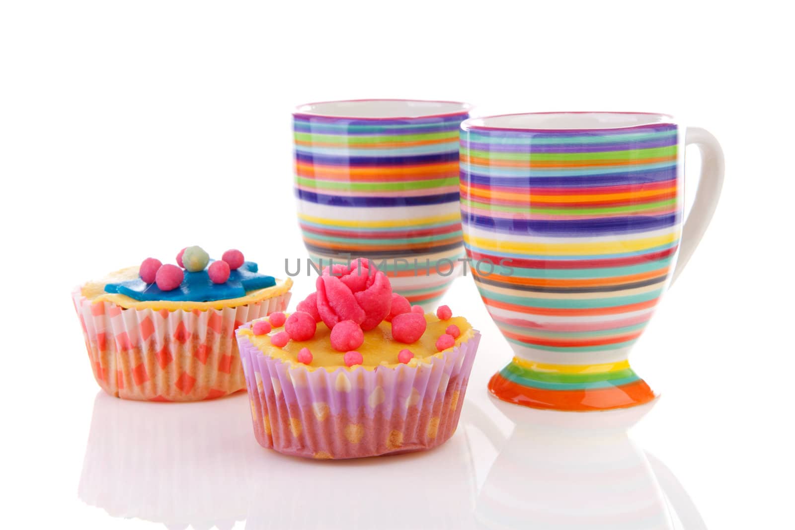 Decorated colorful cupcakes and cups of coffee over white background