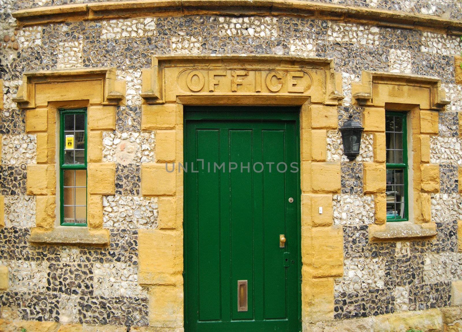 Country house stonewall, green wooden door, office