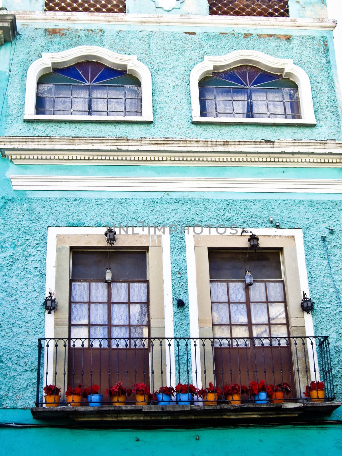 Mexican building with flowerpots by emattil