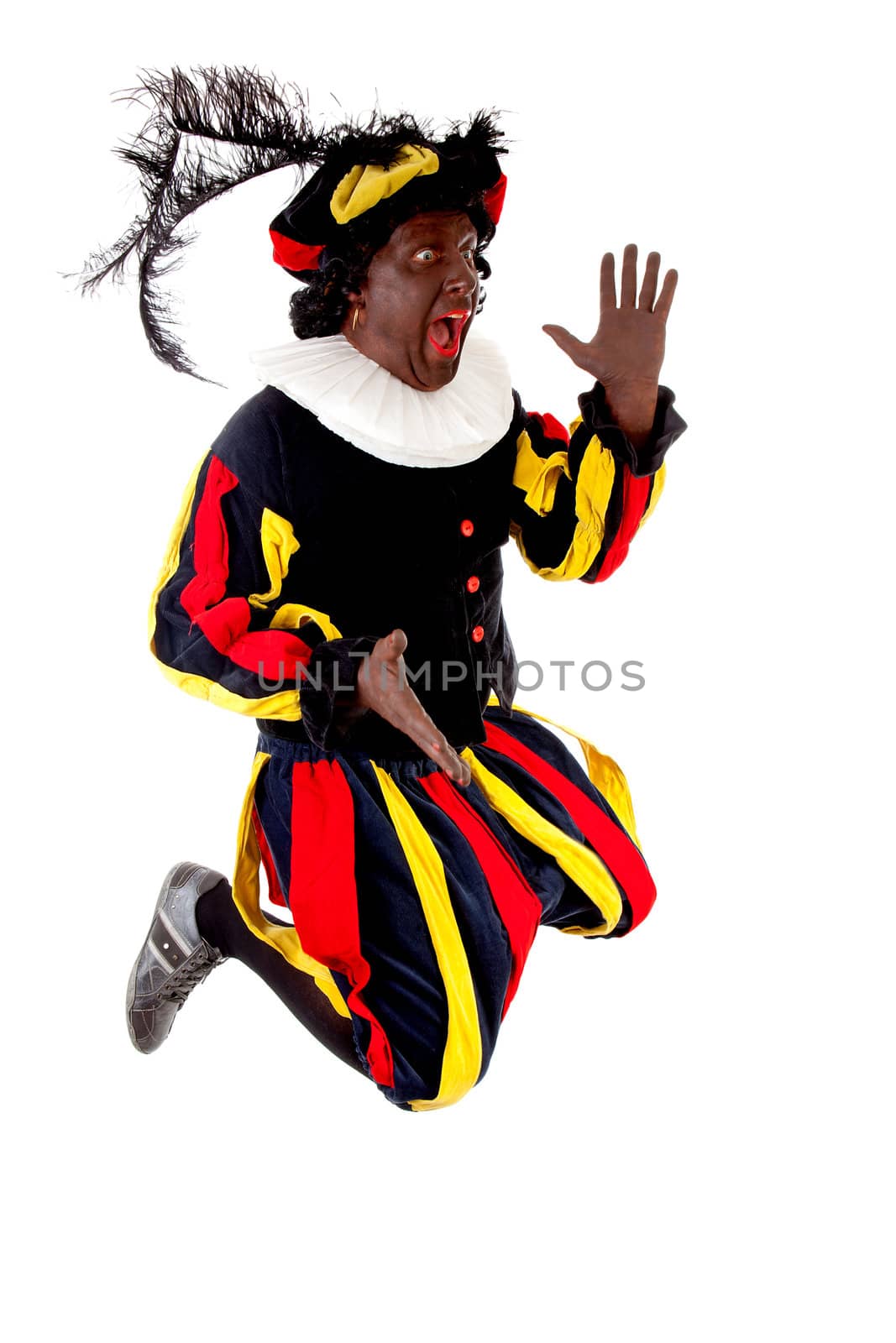 Excited jumping Zwarte piet ( black pete) typical Dutch character part of a traditional event celebrating the birthday of Sinterklaas in december over white background 