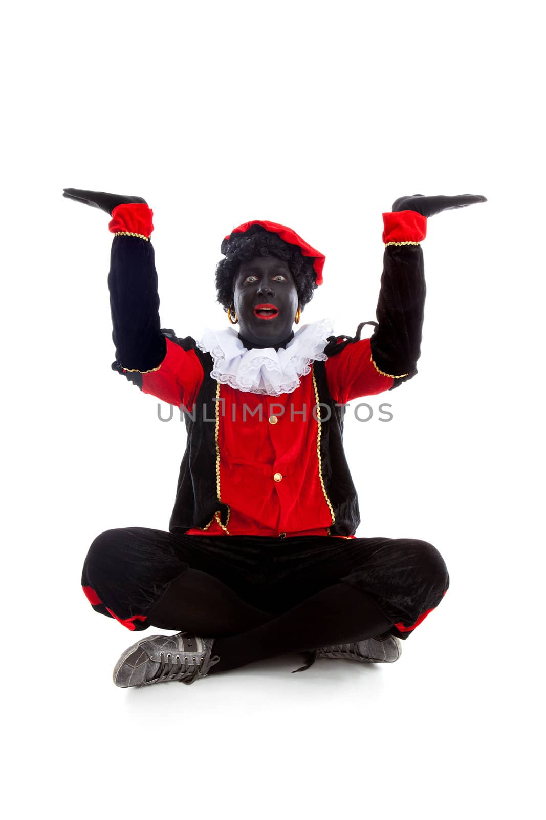 Zwarte piet ( black pete) typical Dutch character part of a traditional event celebrating the birthday of Sinterklaas in december over white background with hands up