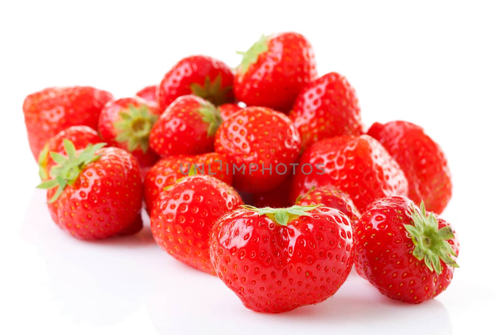 Couple of fresh strawberries in closeup over white background