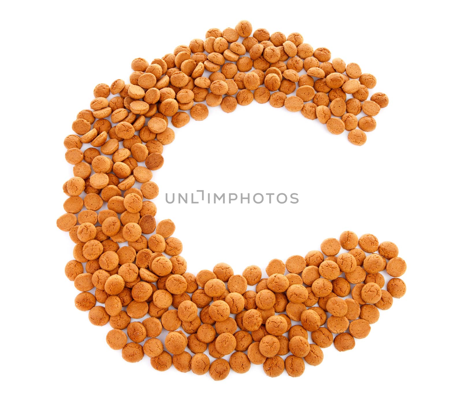 Ginger nuts, pepernoten, in the shape of letter C isolated on white background. Typical Dutch candy for Sinterklaas event in december