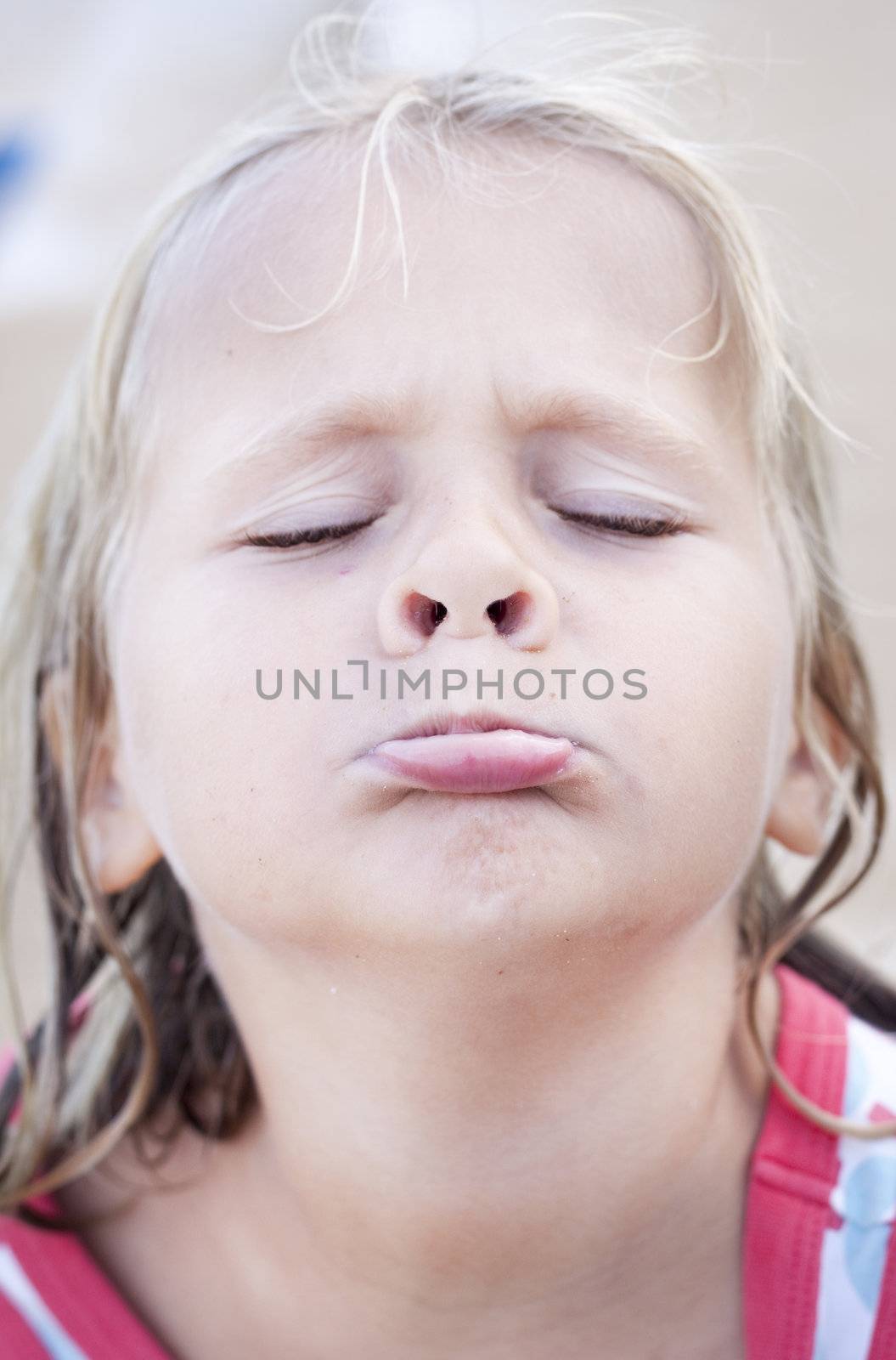 A girl pouting, making a funny face