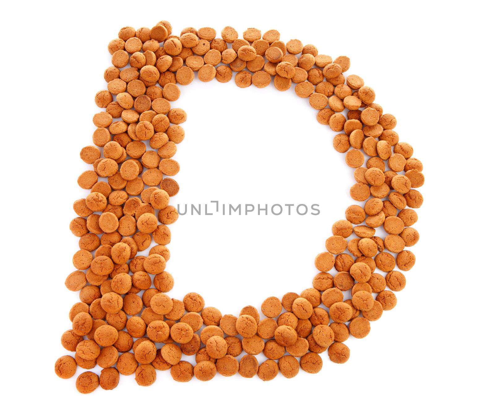 Ginger nuts, pepernoten, in the shape of letter D isolated on white background. Typical Dutch candy for Sinterklaas event in december