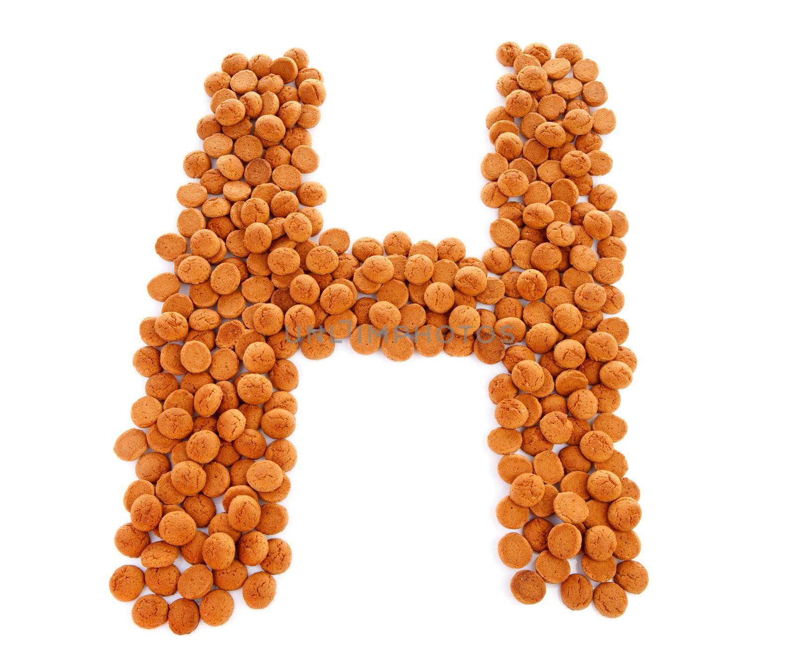 Ginger nuts, pepernoten, in the shape of letter H isolated on white background. Typical Dutch candy for Sinterklaas event in december