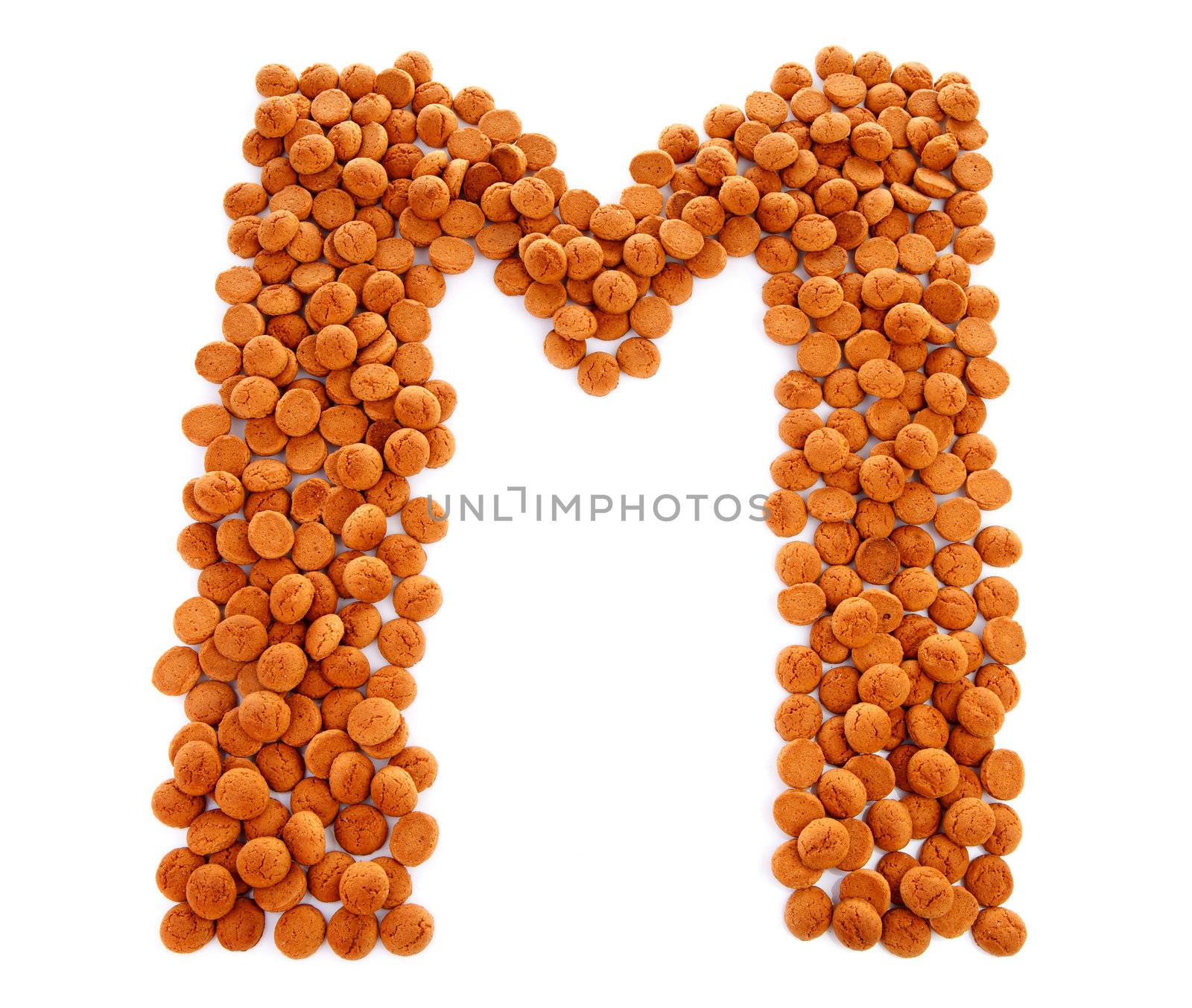 Ginger nuts, pepernoten, in the shape of letter M isolated on white background. Typical Dutch candy for Sinterklaas event in december