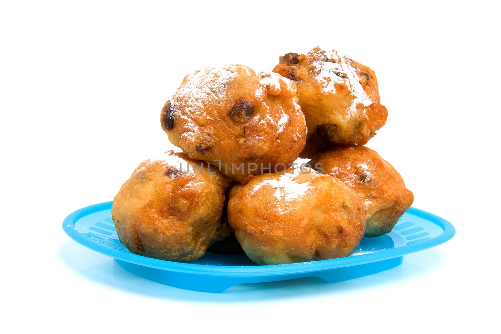 blue plate with Dutch donut also known as oliebollen, traditional New Year's eve food isolated on white background