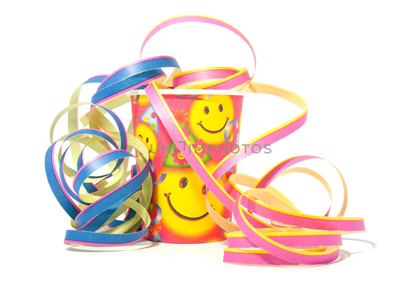 party decoration with cup and streamers over white background