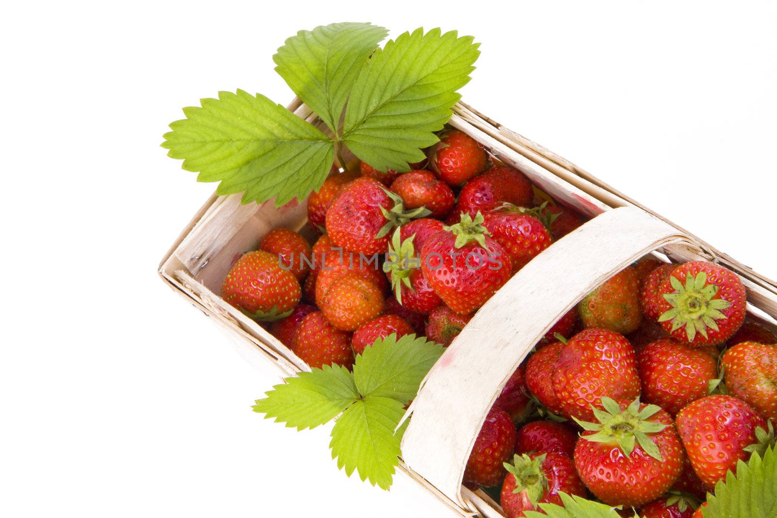 Fresh juicy strawberries in wooden basket isolated on white