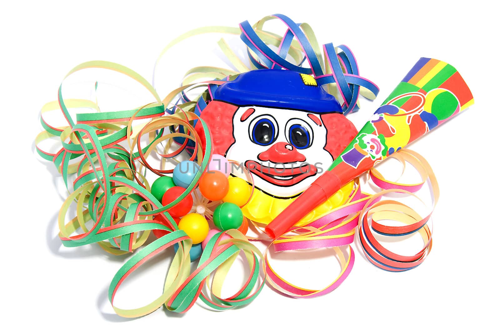 party decoration with horn, clown and streamers over white background