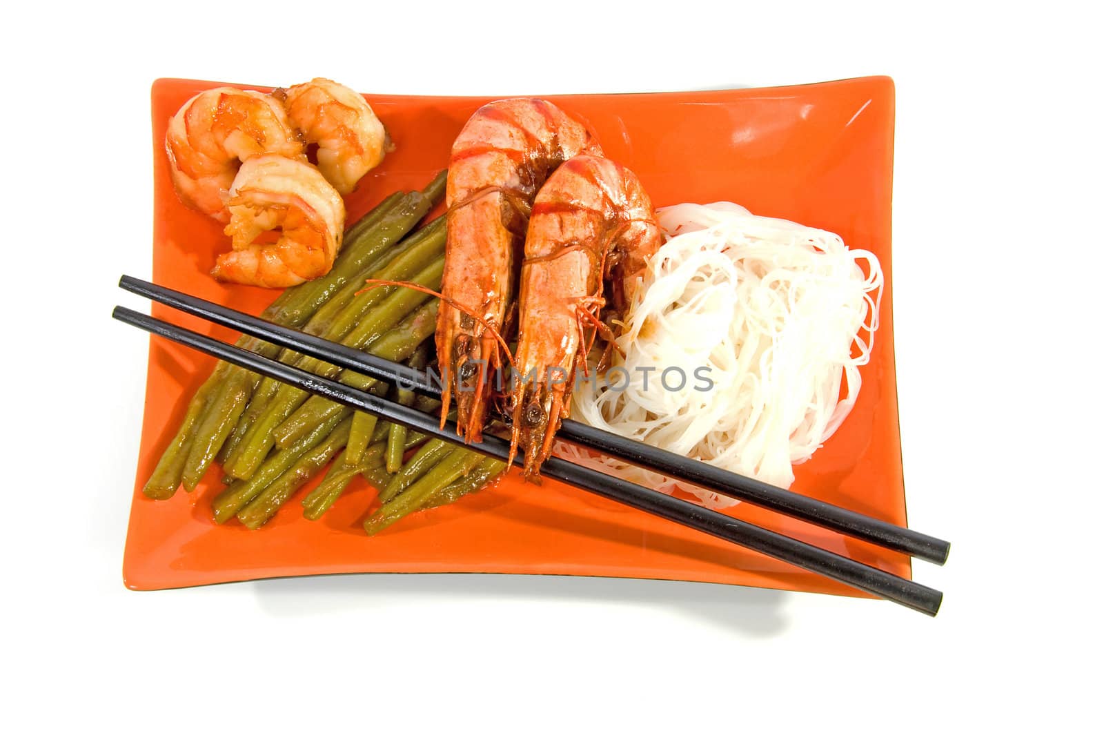 Oriental meal on orange plate isolated over white background