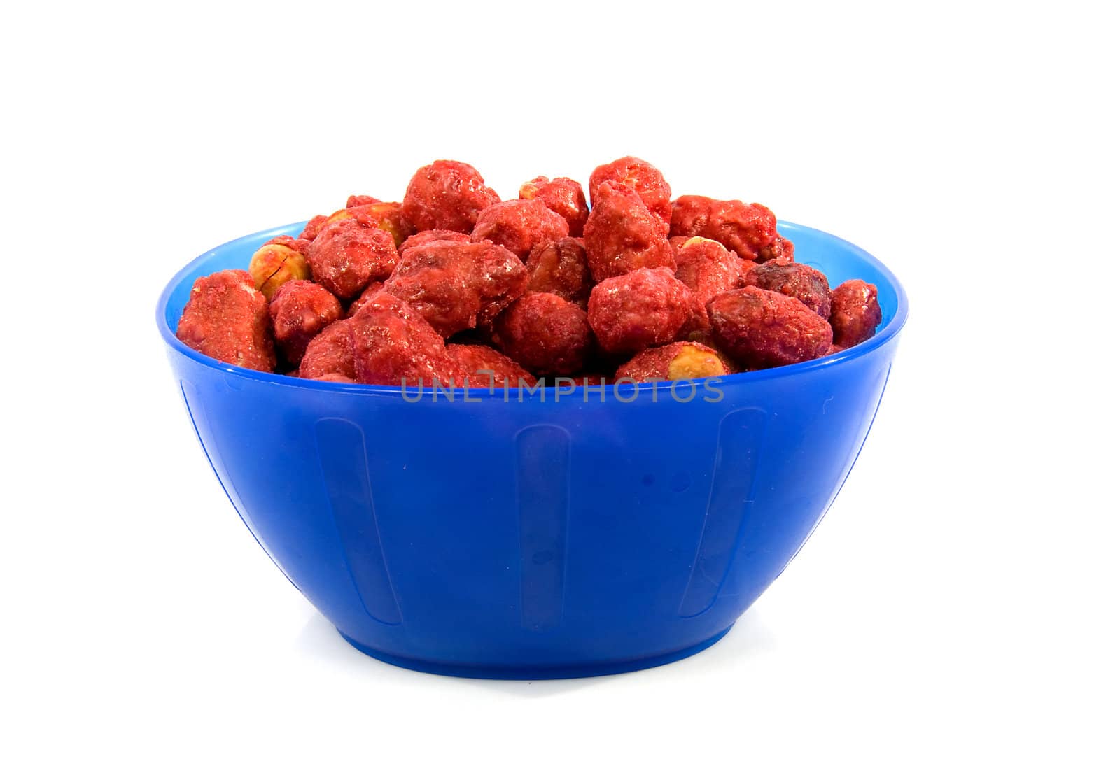 Blue bowl with sugared peanuts over white background