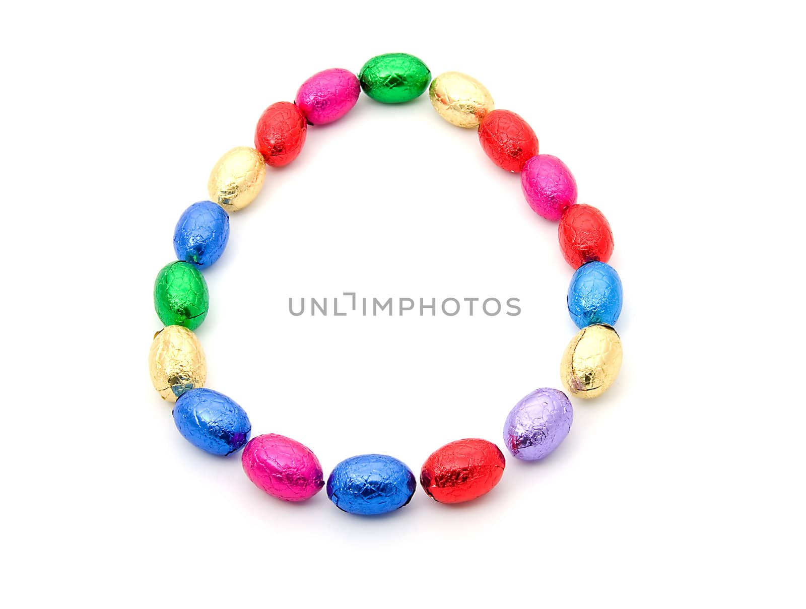 colorful chocolate easter eggs in circle over white background