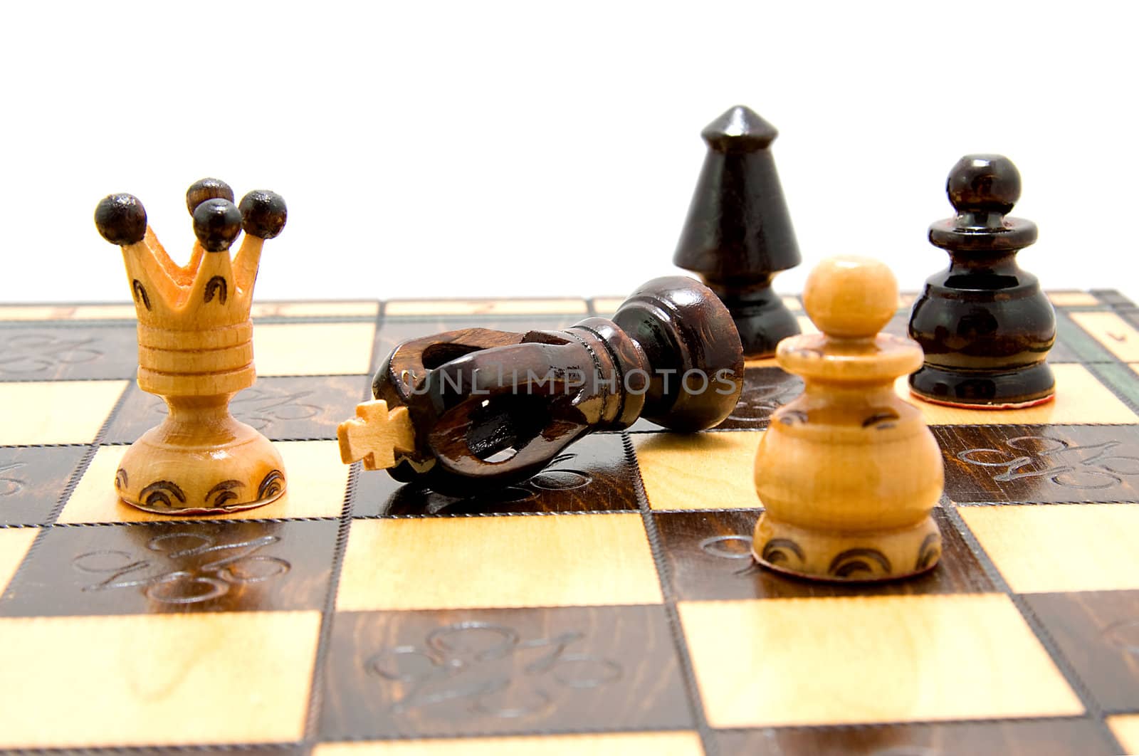 chess pieces on chess-board with fallen king over white background