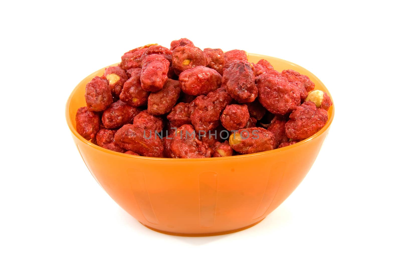 Orange bowl with sugared peanuts over white background