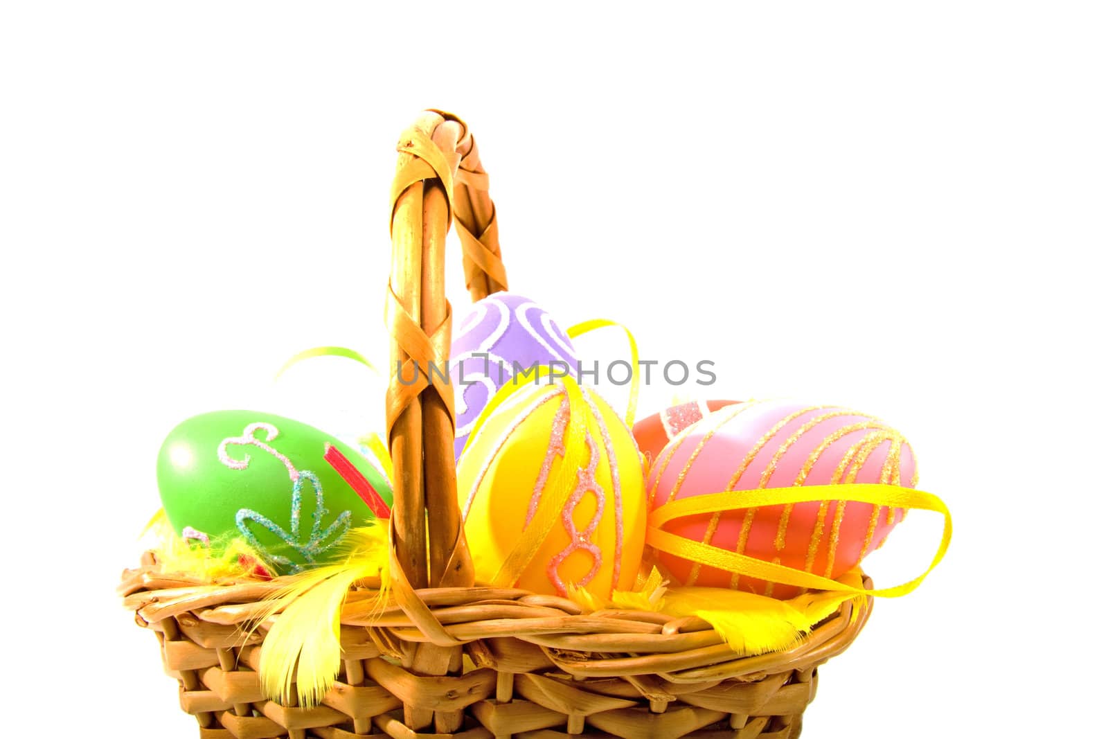 Cane basket with colorful easter eggs over white background