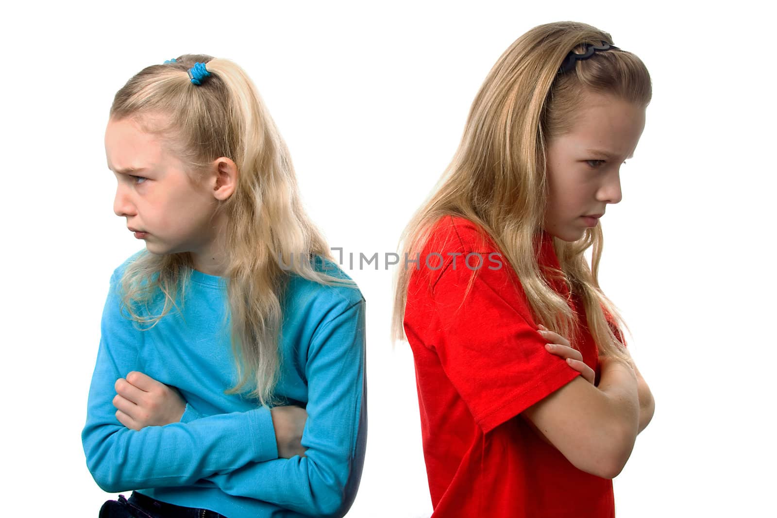 Two young blonde girls are angry at each other over white background