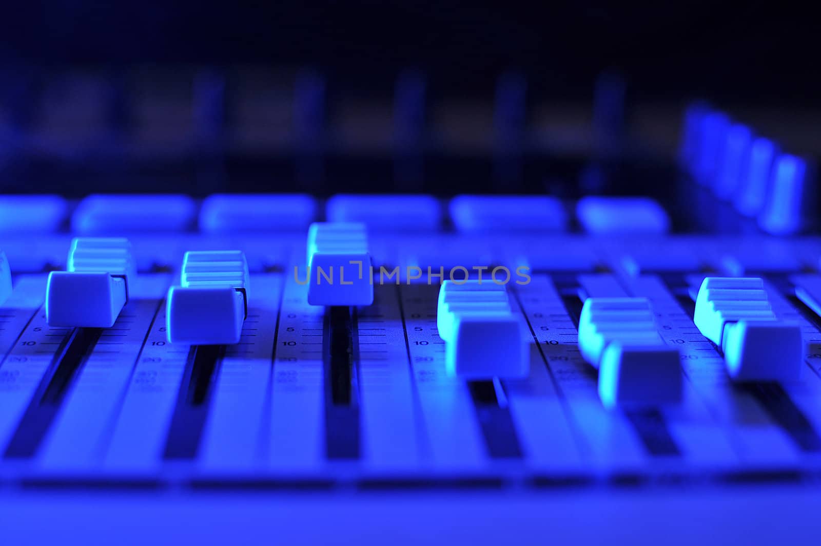 Mixing console illuminated by blue light