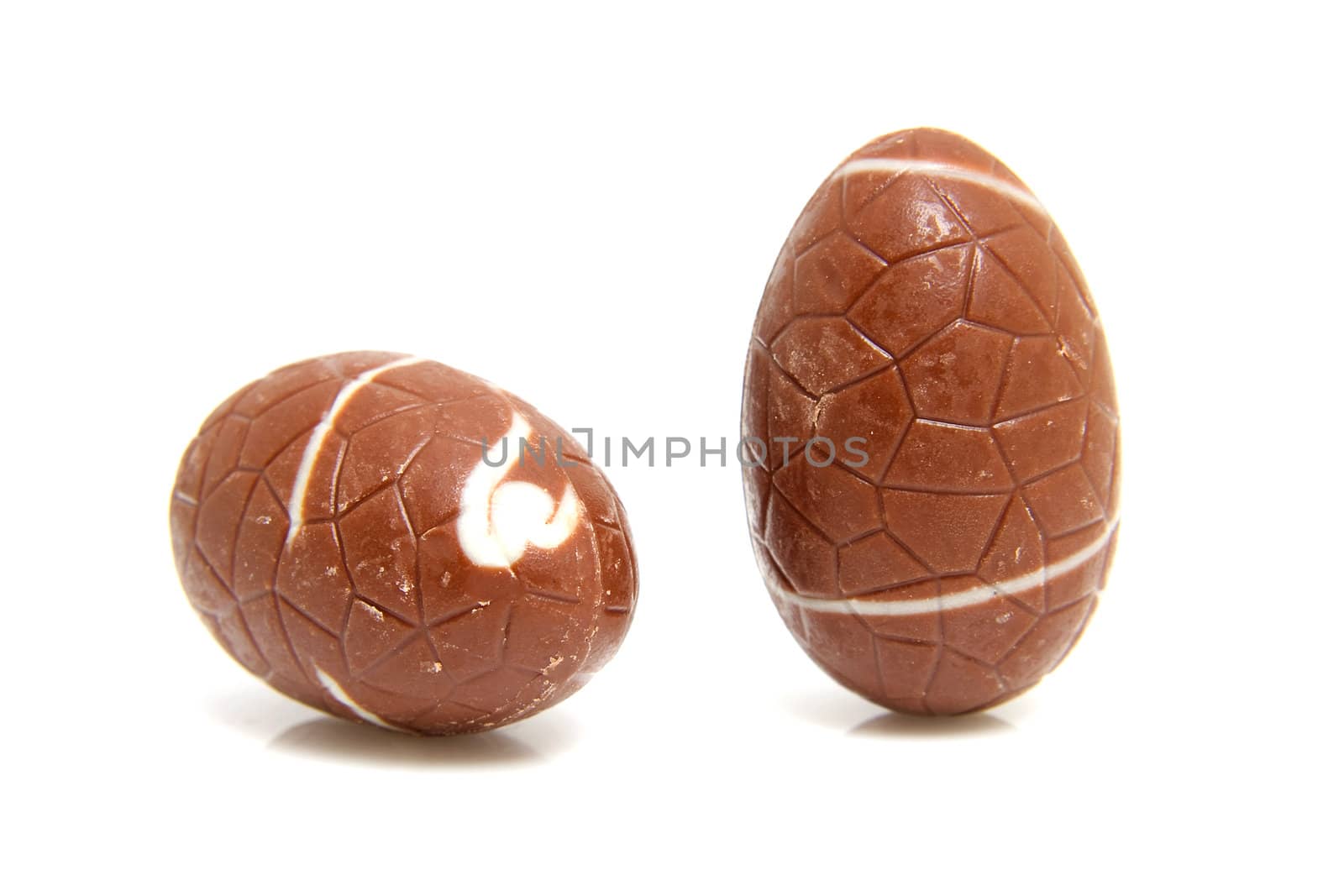 two chocolate easter eggs over white background