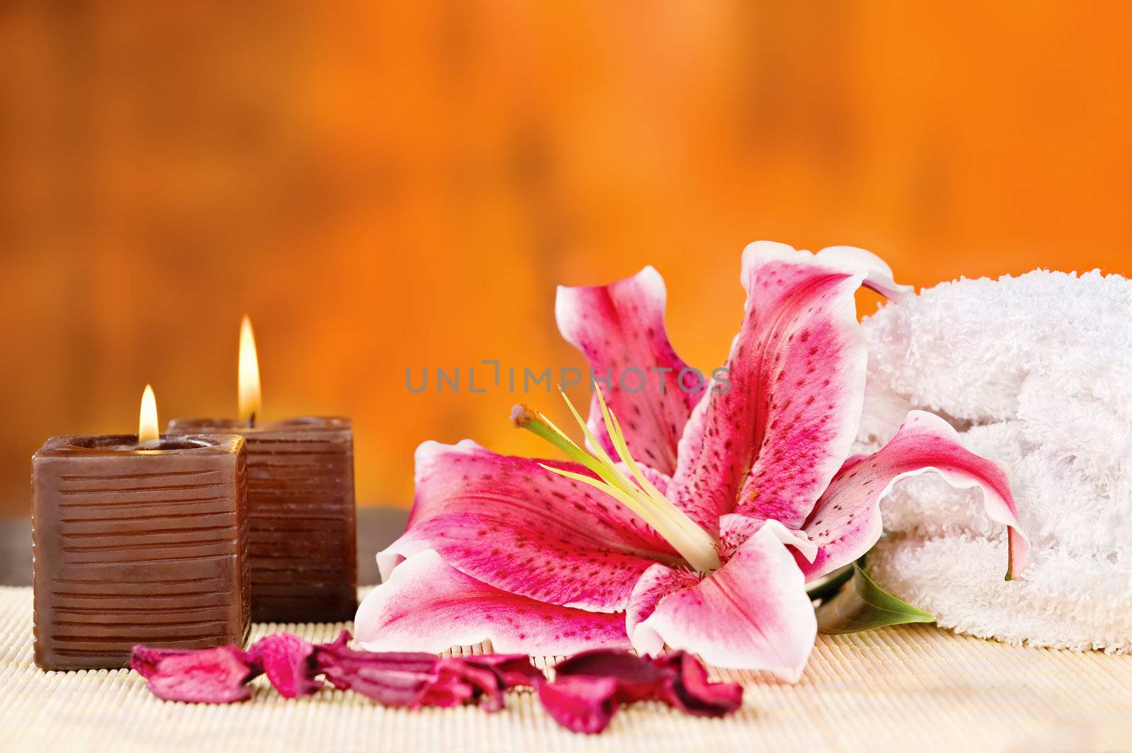 Par of candles with towel and orchid