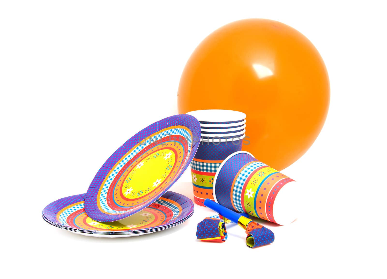 stack of birthday plates and cups with noisemakers isolated on white background