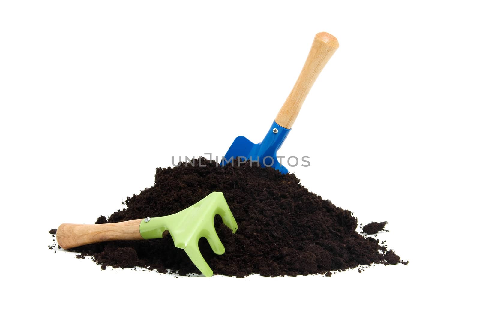 gardening tools and pile of garden soil over white background