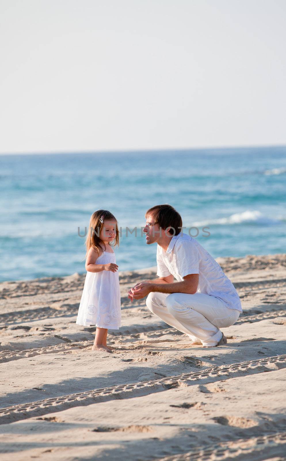 happy family father and daughter on beach having fun by juniart