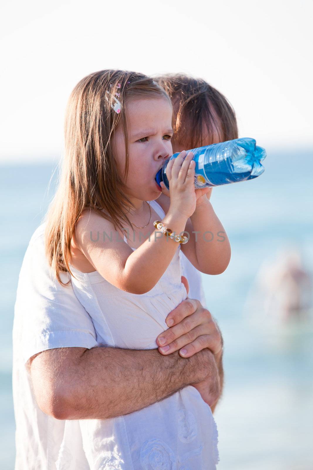 happy family father and daughter on beach having fun summer vacation