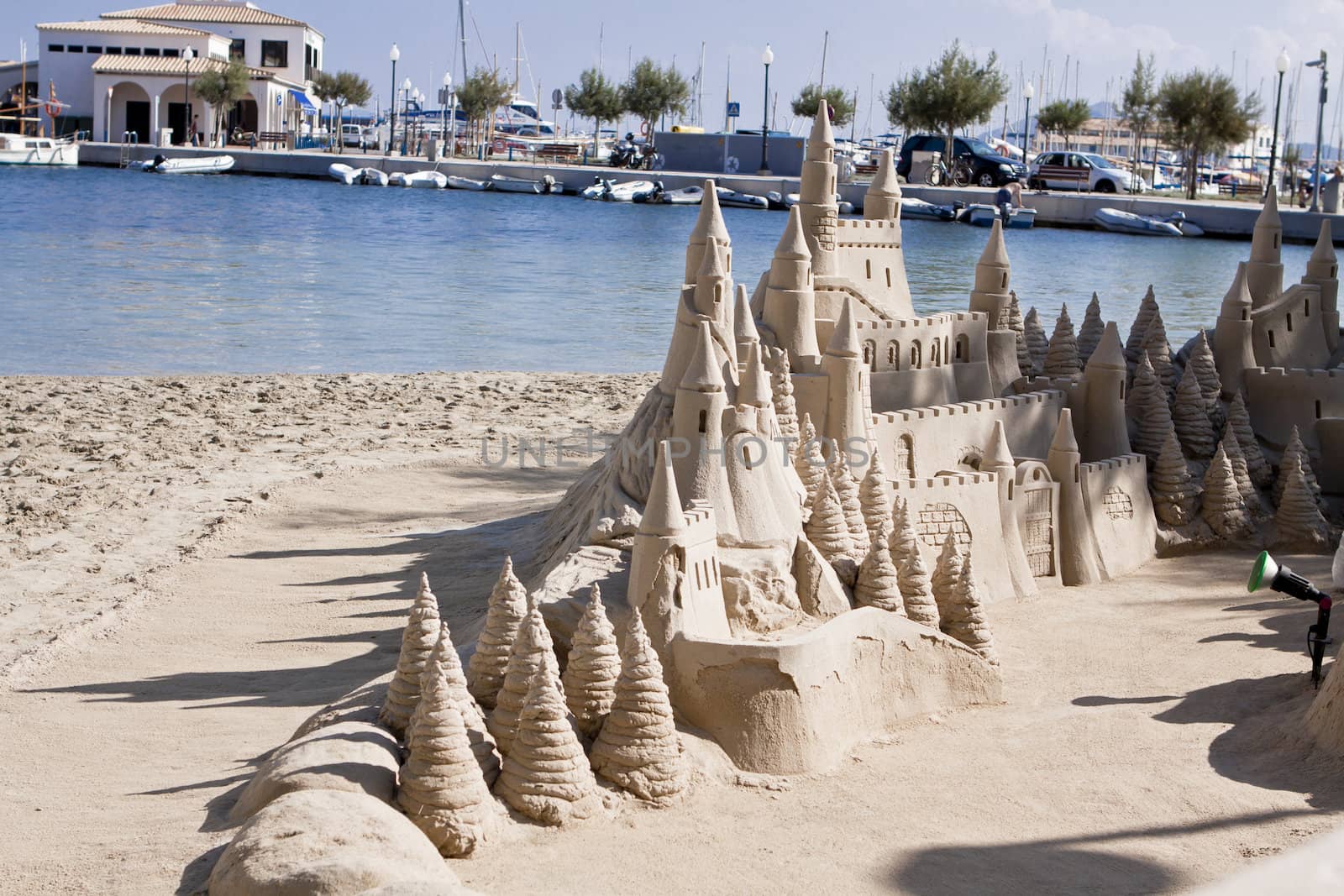 creative big sandcastle on the beach in summer blue sky