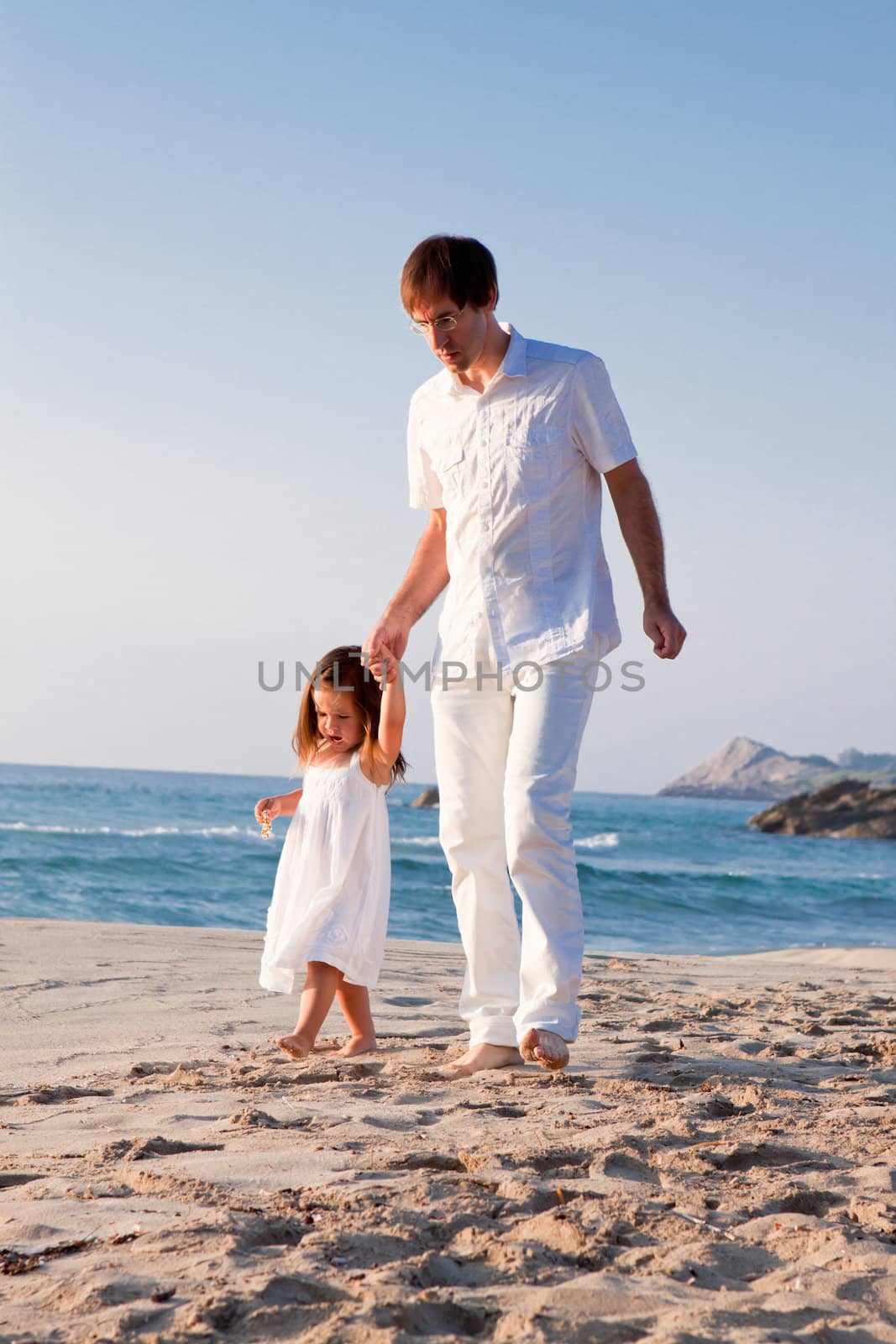 happy family father and daughter on beach having fun by juniart