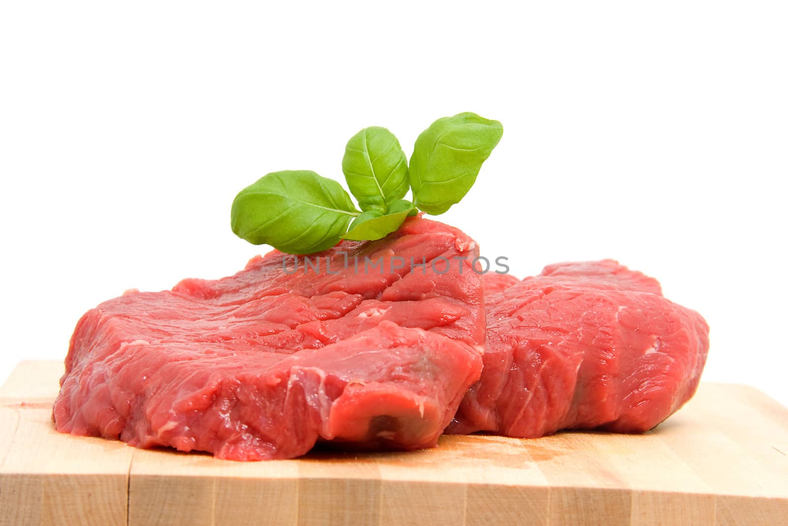 Raw steak meat on cutting board over white background
