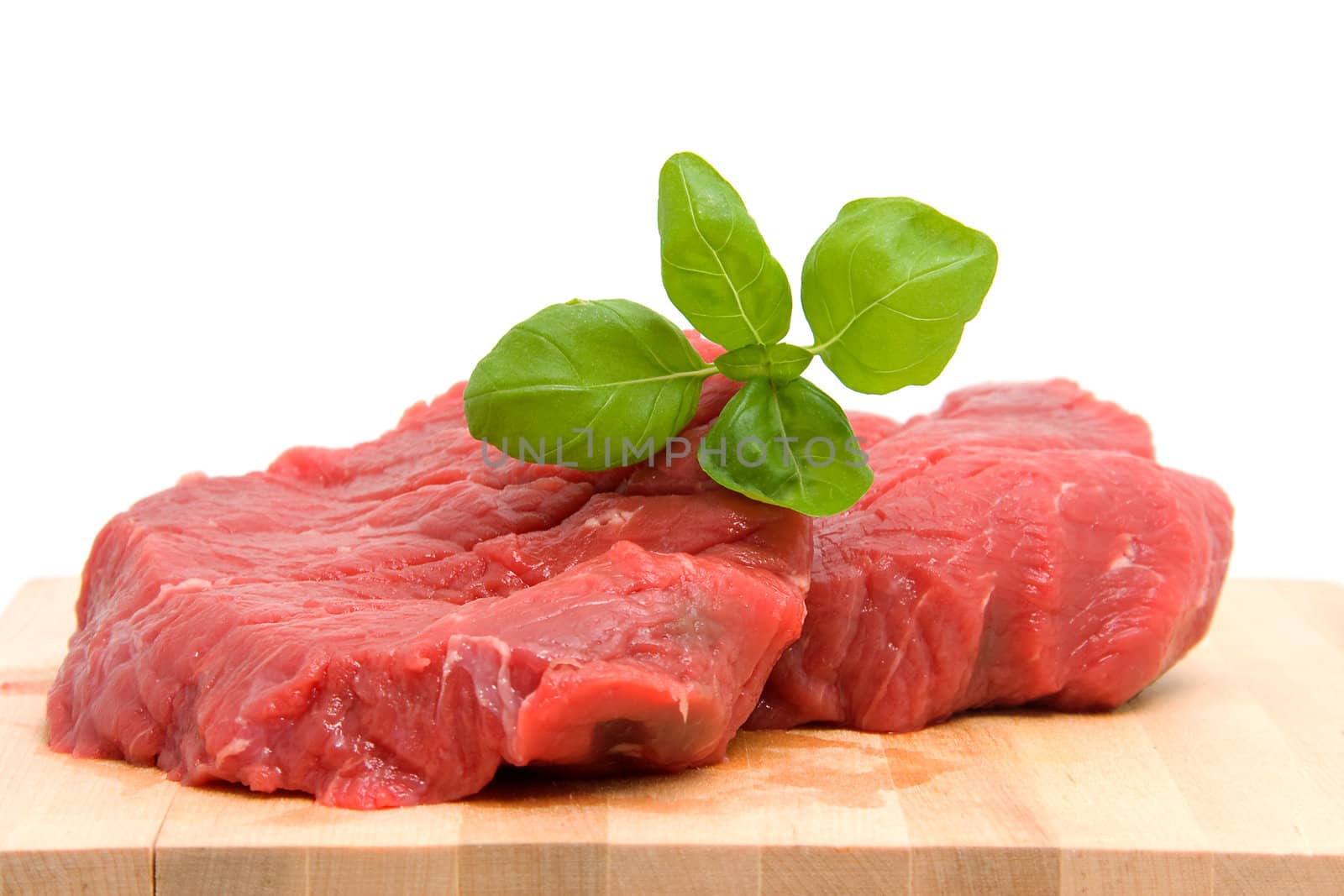Raw steak meat on cutting board over white background