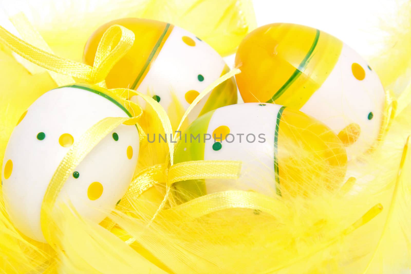 closeup of easter eggs in yellow feathers