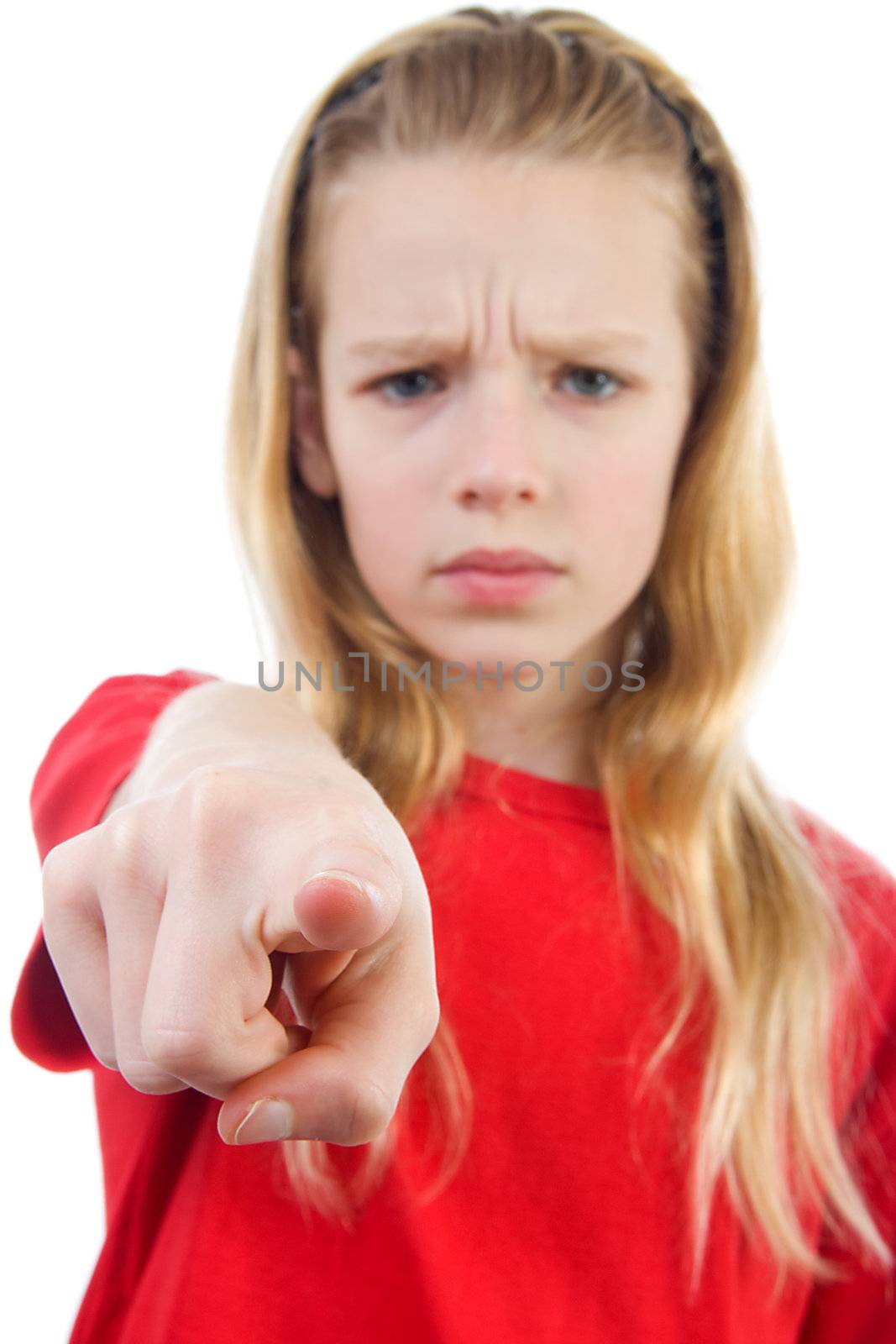 Angry girl is pointing at you, finger closeup, girl in blur over white background