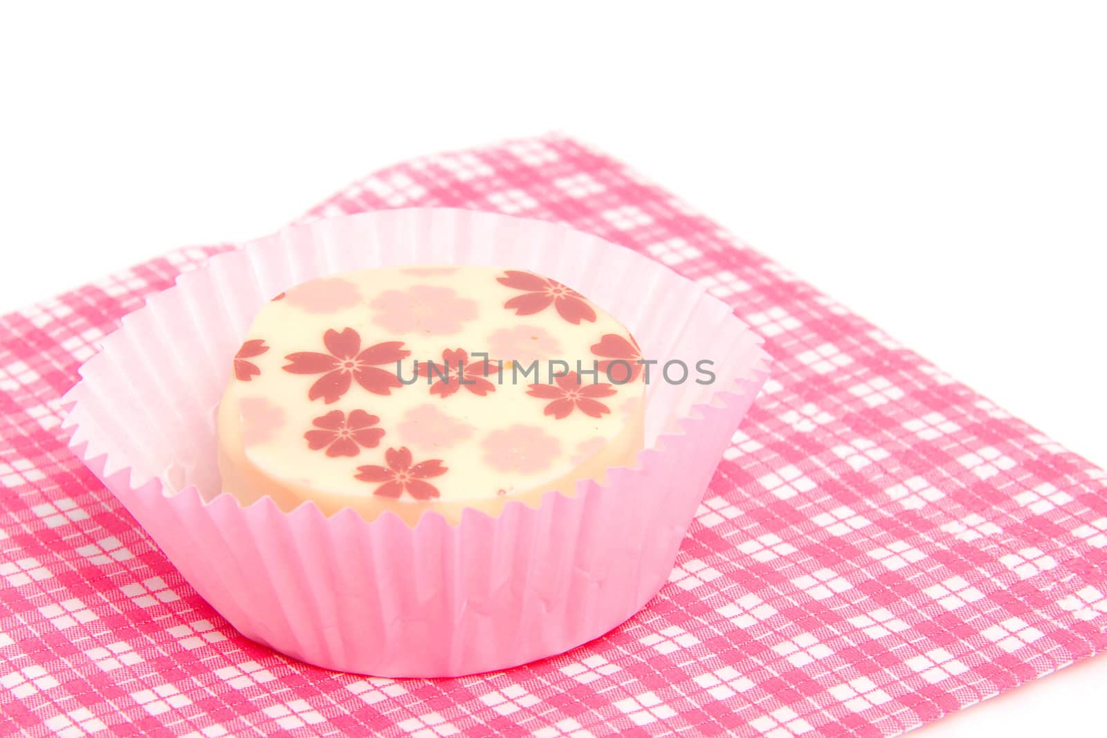 petit four on checkered napkin over white background