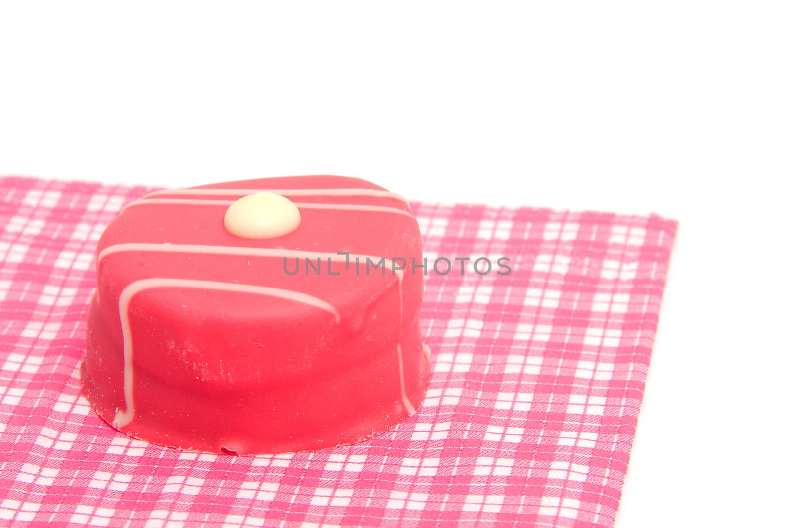 petit four on checkered napkin over white background