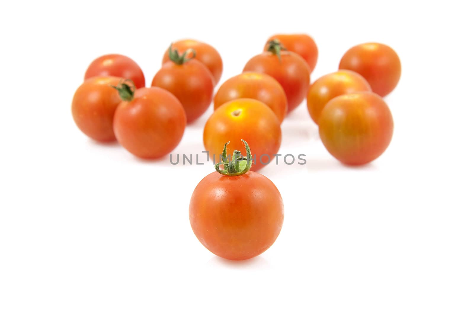Bunch of fresh cherry tomatoes over white background