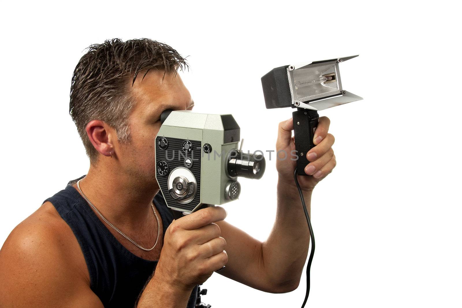 Man is filming with old fashioned film camera over white background