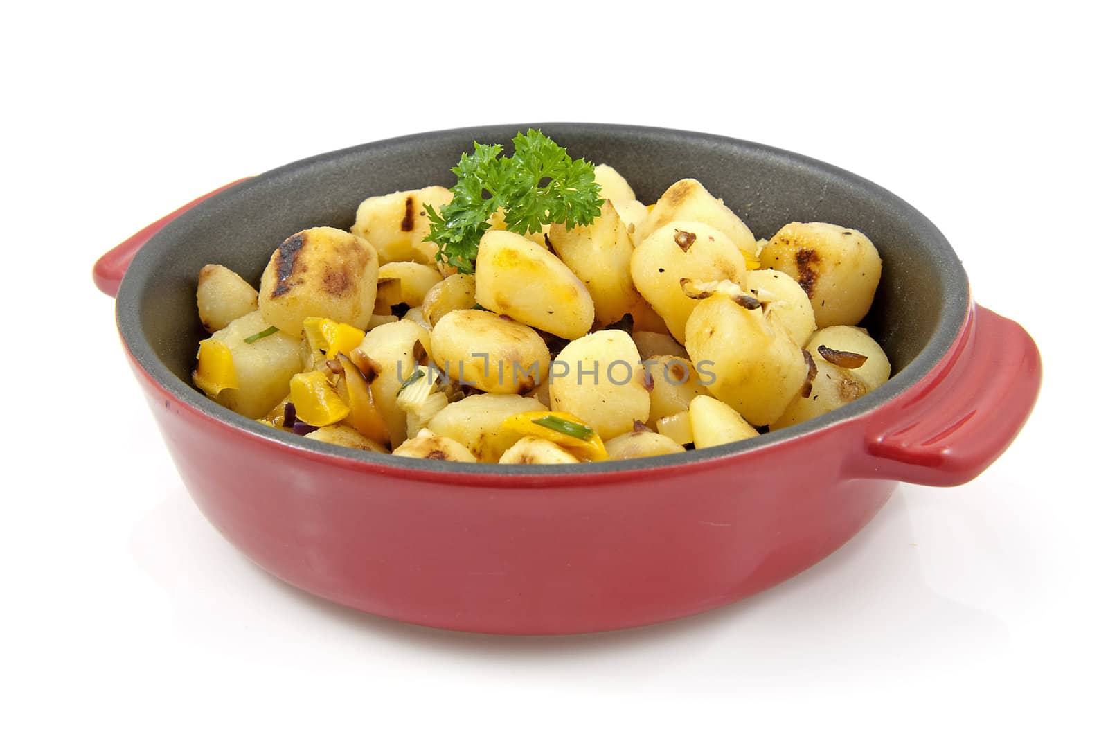 red pan with fresh baked potatoes over white background